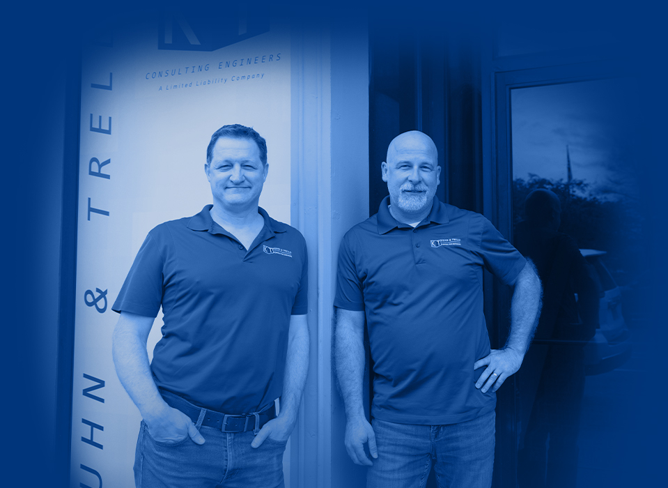 kuhn and trello standing in office lobby