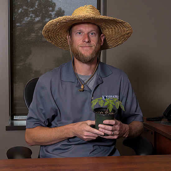 Joe Holthaus holding gardening supplies