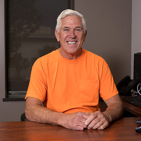 John Sestak wearing bright orange shirt
